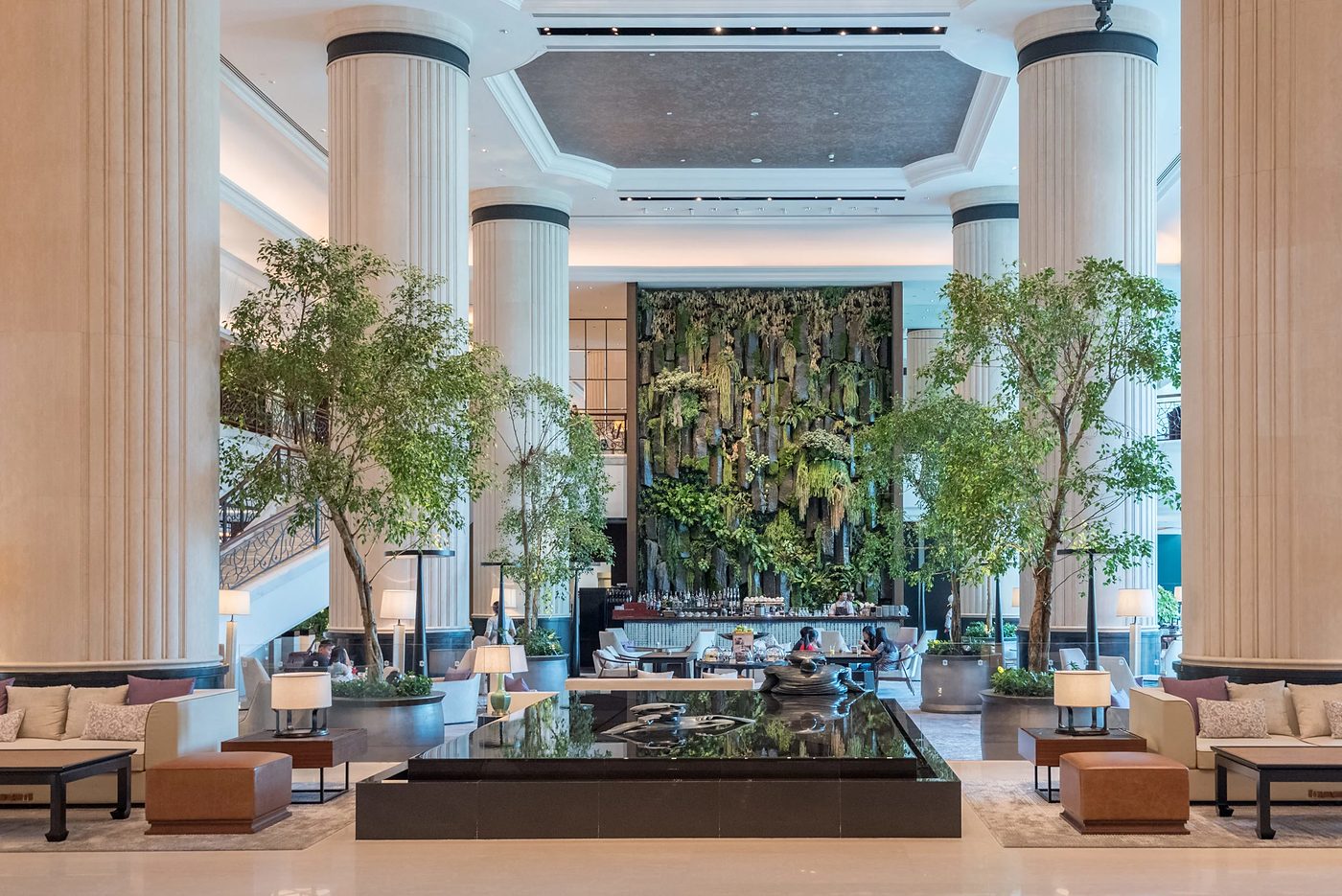 The lobby at Shangri-La Singapore, with its living green wall, full-height columns and indoor trees