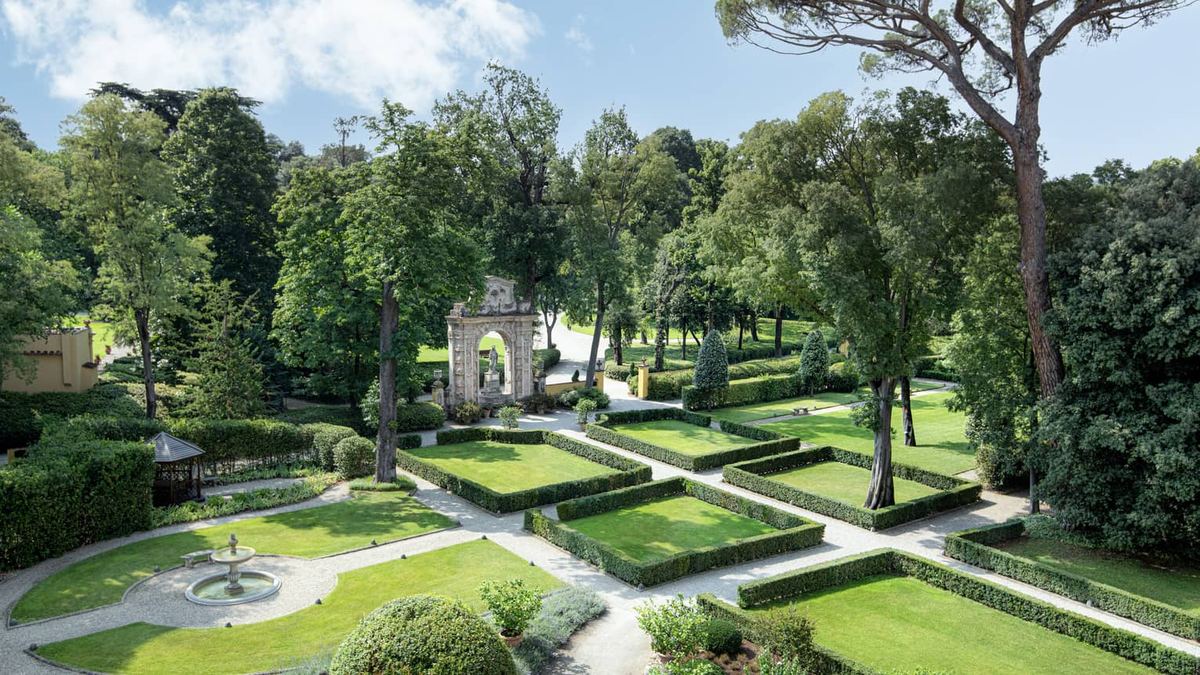 The Giardino della Gherardesca seen from above, with clipped box parterres, gravel paths and a stone portal