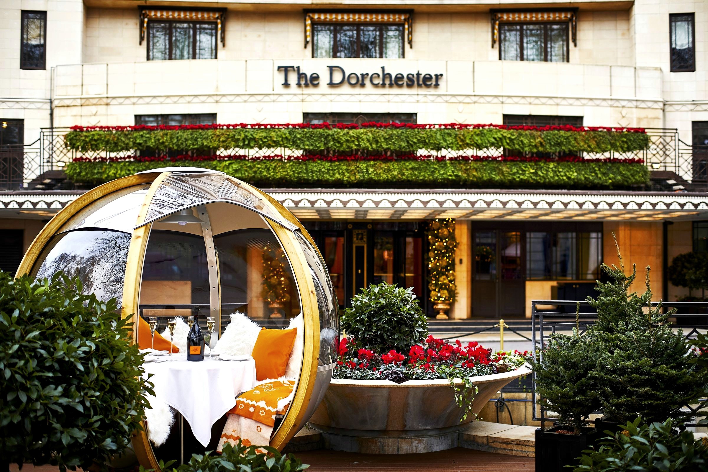 The Dorchester's Park Lane entrance with a festive glass dining pod