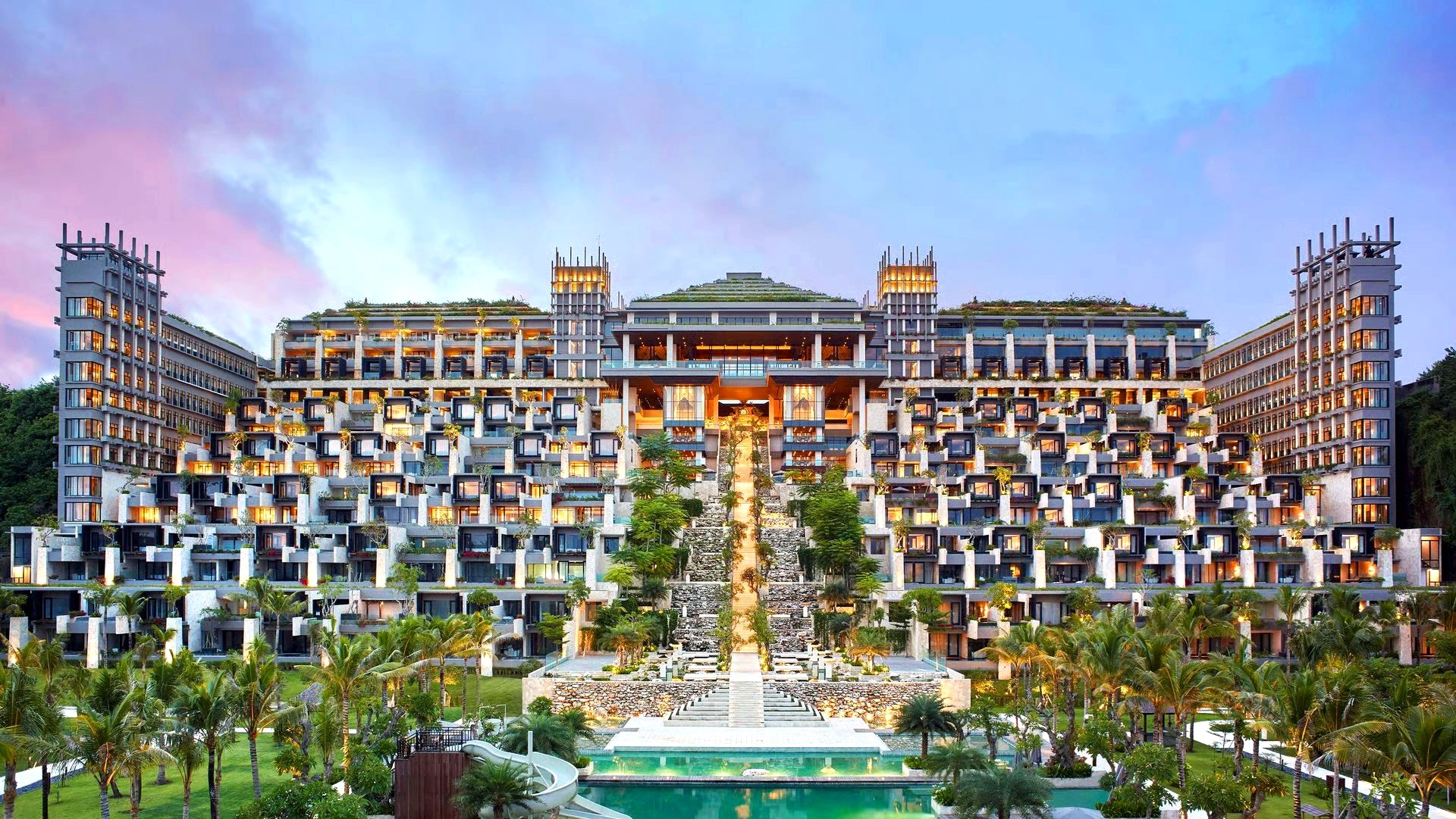 Kempinski resort terraced across a hillside at dusk