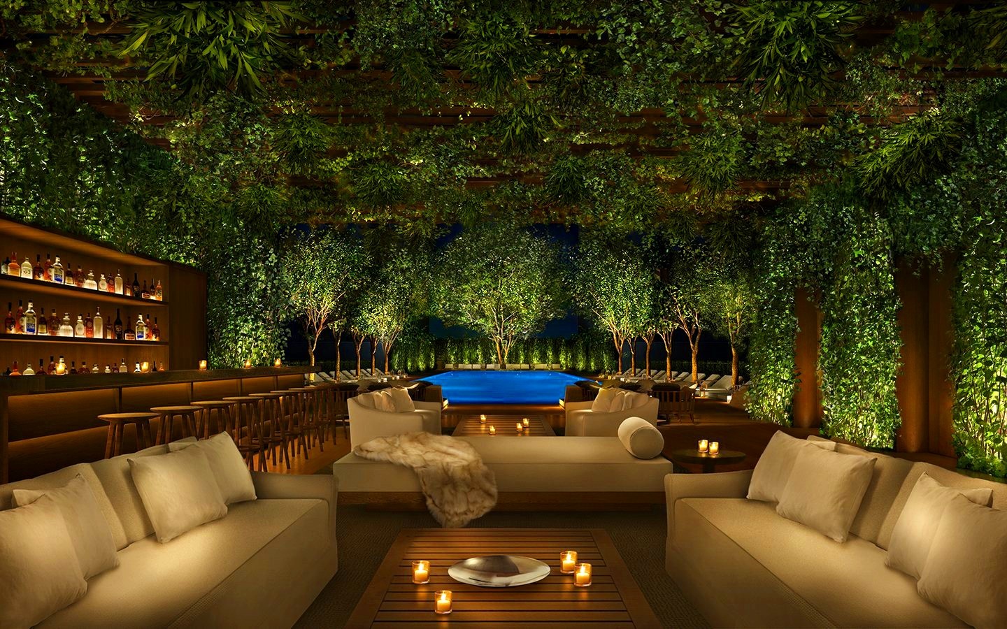 Poolside lounge under a hanging garden canopy at night