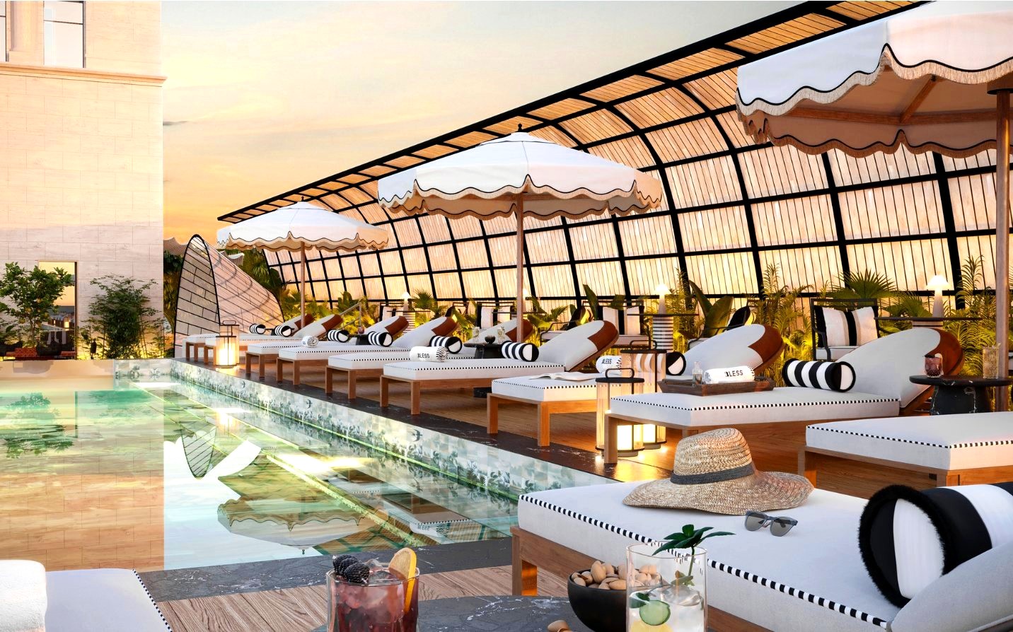 Rooftop pool lounge with striped umbrellas at sunset