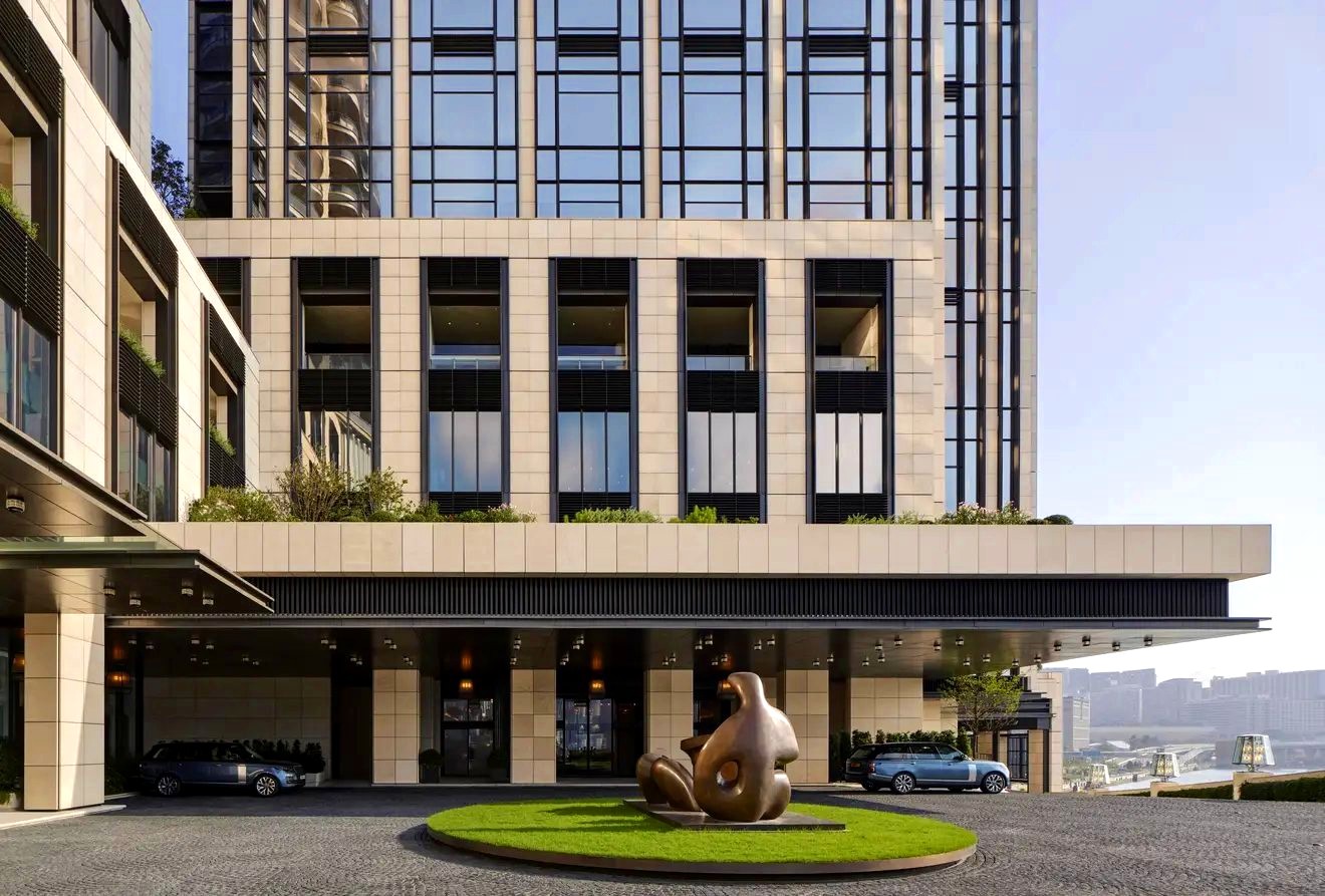 Rosewood hotel entrance with sculpture and glass façade
