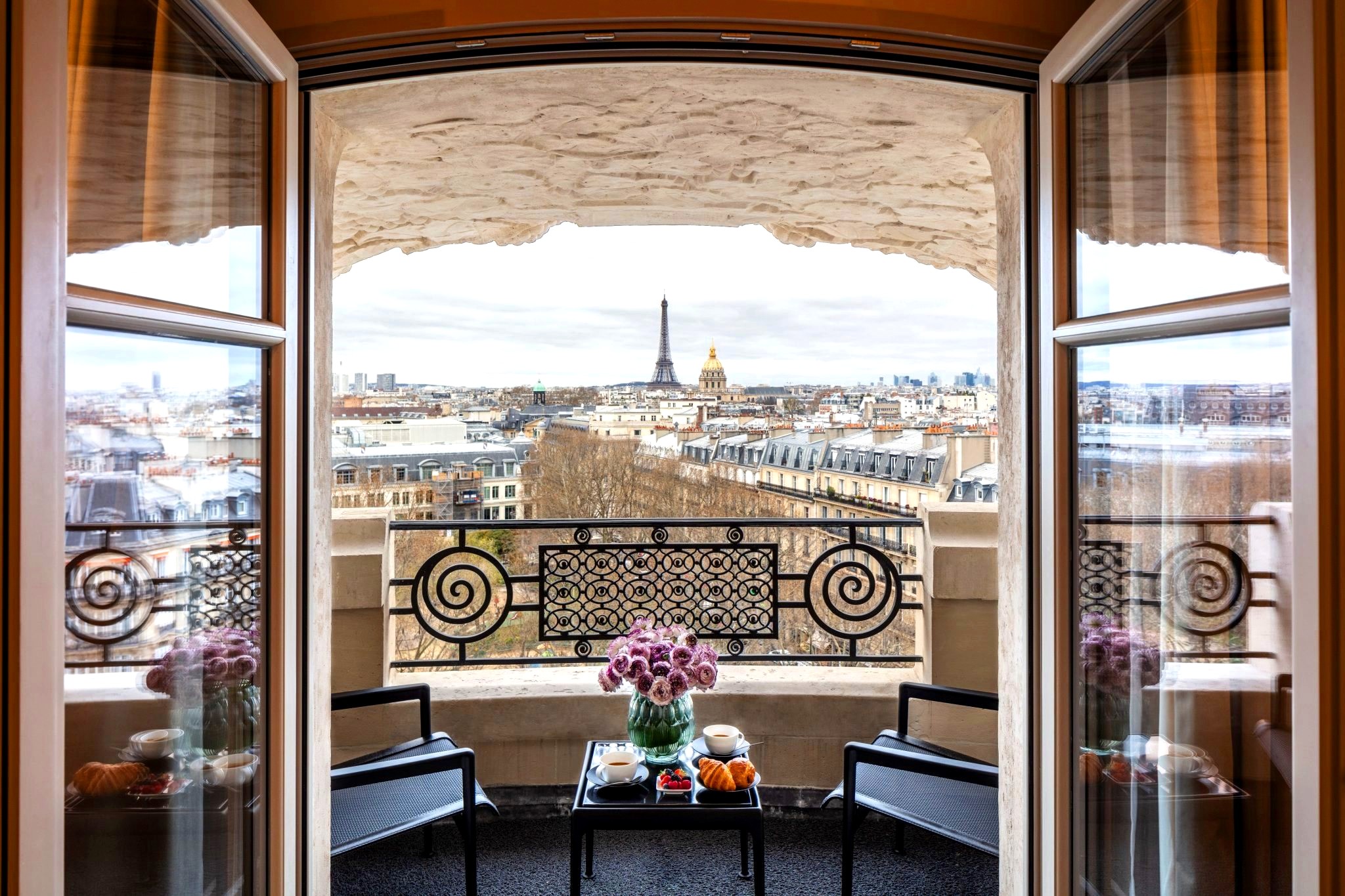Paris hotel balcony framing the Eiffel Tower