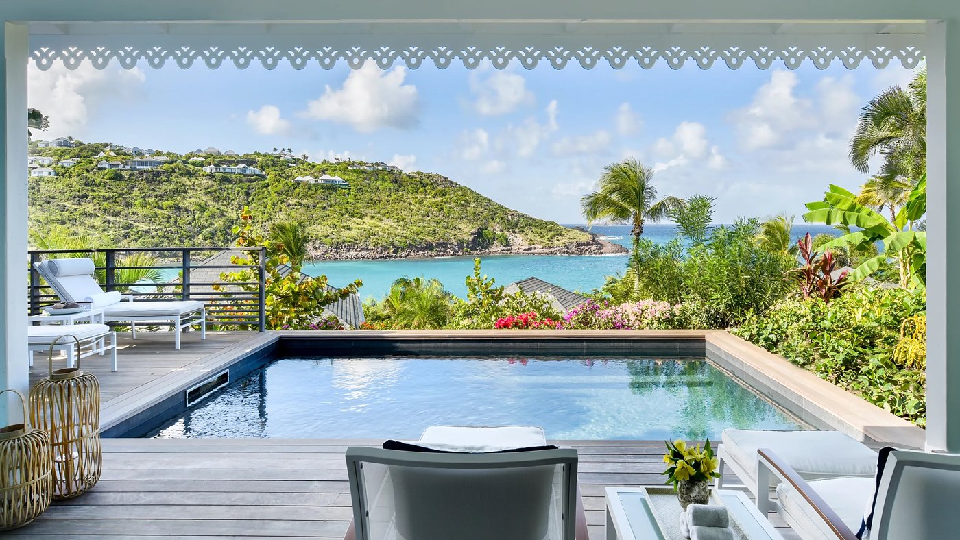 A suite terrace at Rosewood Le Guanahani, St Barth, with its own pool above the bay