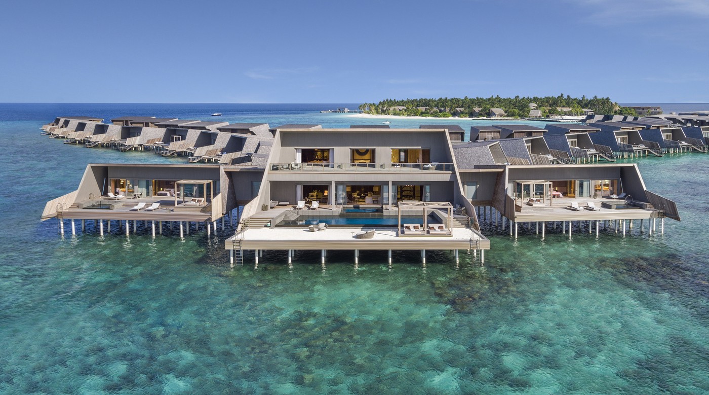 An overwater residence at St. Regis Vommuli, its wings angled around a private pool above the reef