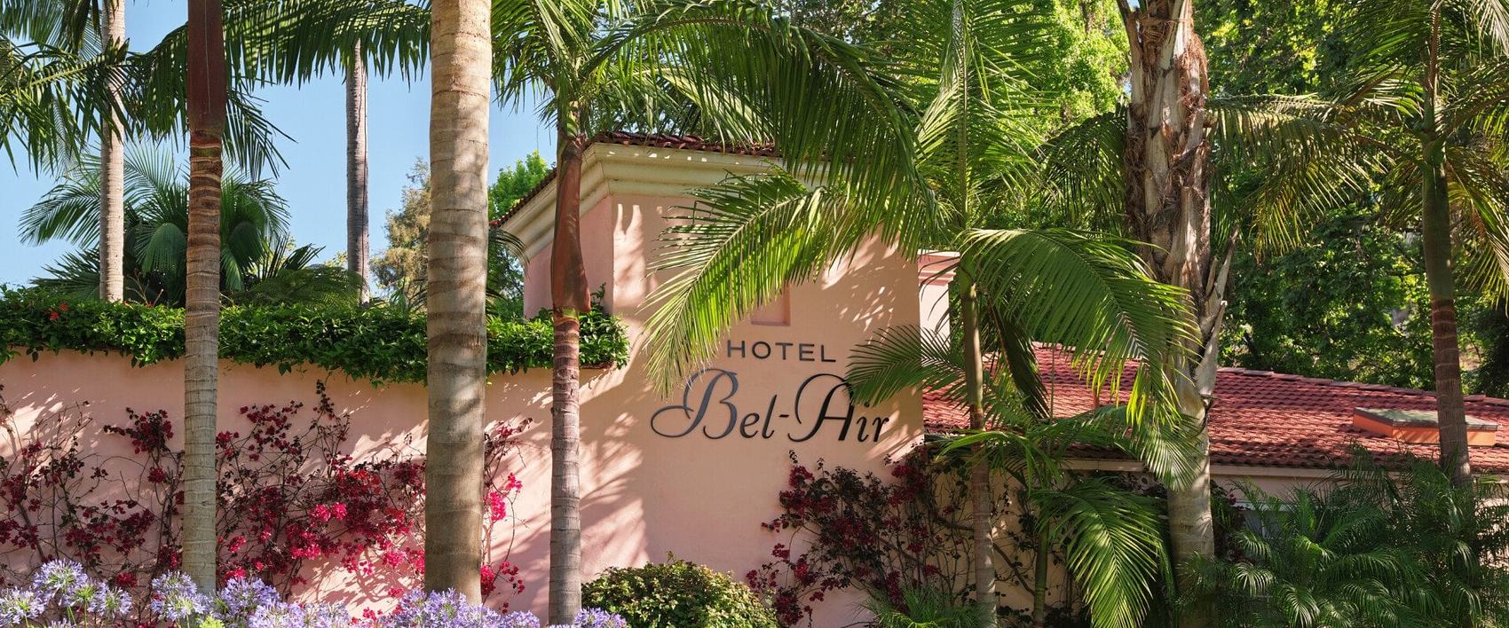 The Hotel Bel-Air entrance sign among palms and bougainvillea, Los Angeles