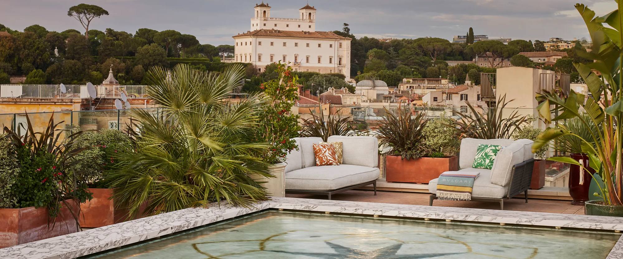 The rooftop terrace and pool at Bulgari Hotel Roma, Villa Medici beyond