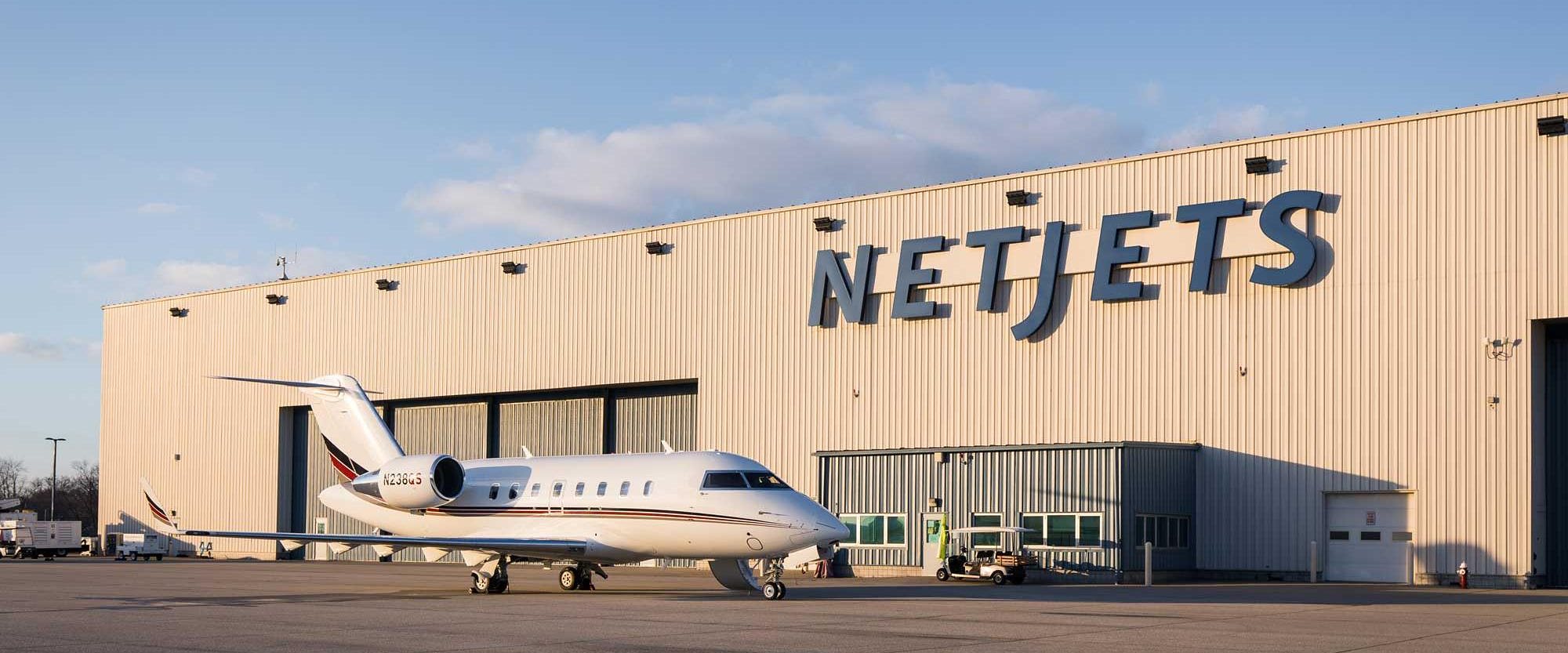 A NetJets aircraft on the apron outside the company hangar
