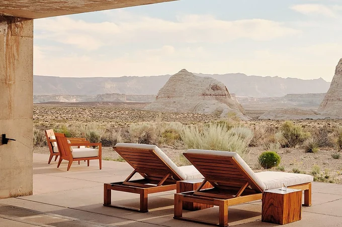 Loungers on a desert terrace at Amangiri, Utah, facing the rock formations