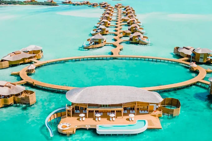 Overwater villas arranged around a lagoon at Soneva Jani in the Maldives