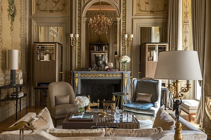 A gilded salon with a marble fireplace at Hotel de Crillon, Paris