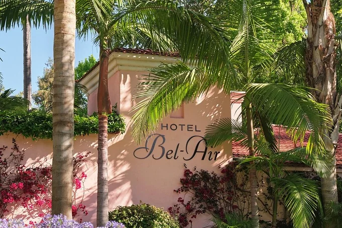 The Hotel Bel-Air entrance sign among palms and bougainvillea, Los Angeles