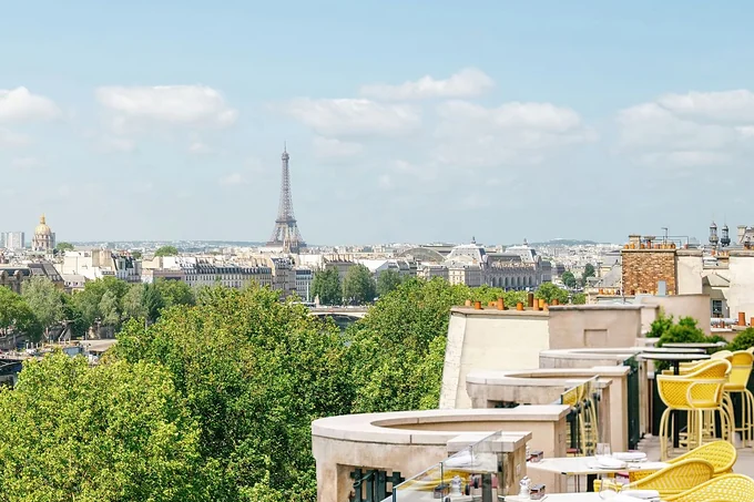 A rooftop terrace at Cheval Blanc Paris looking towards the Eiffel Tower