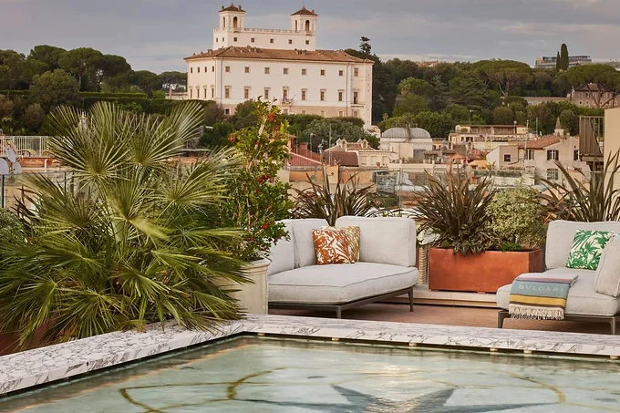 The rooftop terrace and pool at Bulgari Hotel Roma, Villa Medici beyond
