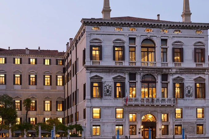 The Aman Venice palazzo lit at dusk on the Grand Canal