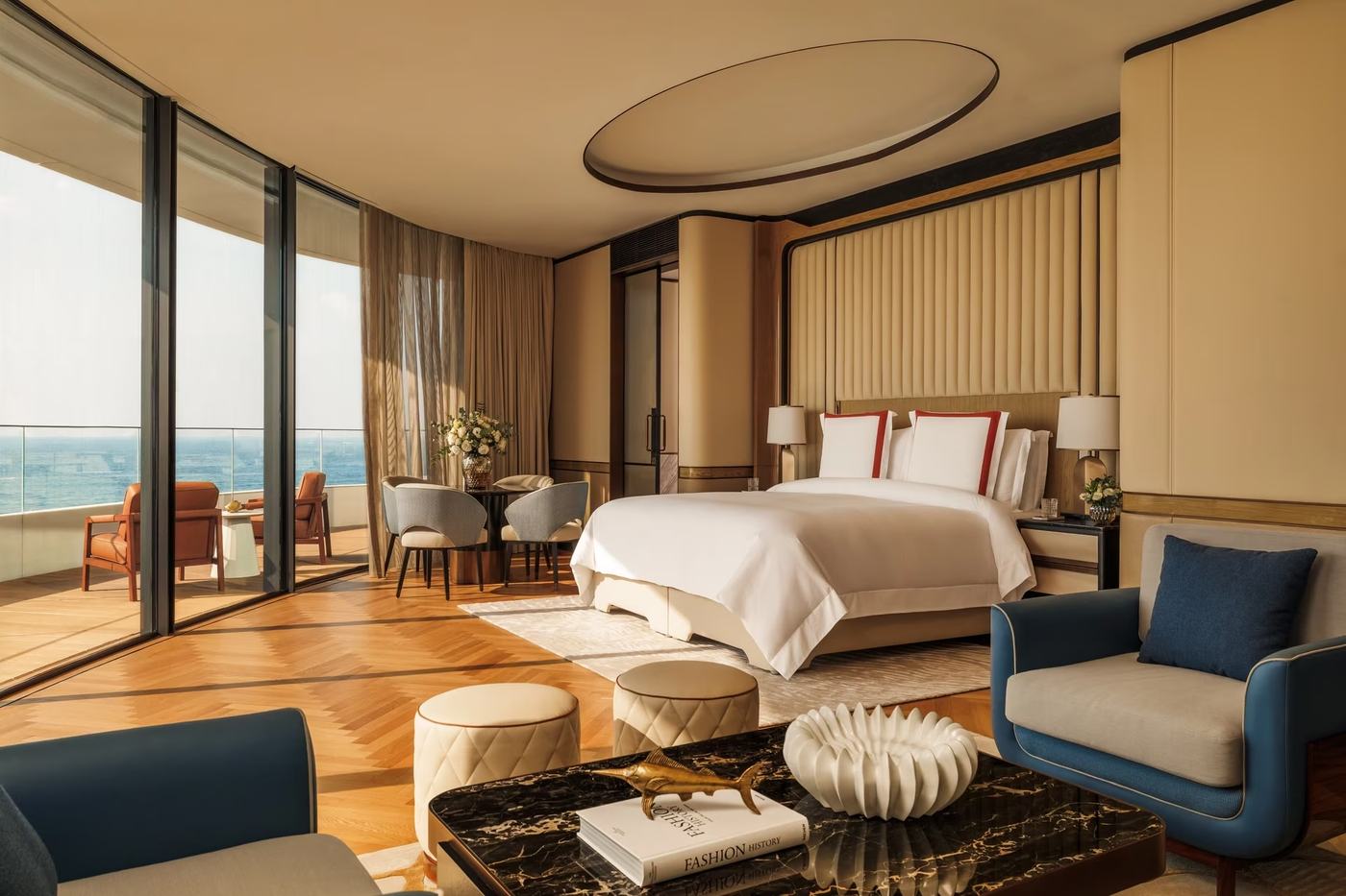 A sea-facing room at Jumeirah Marsa Al Arab with curved floor to ceiling windows and a private terrace