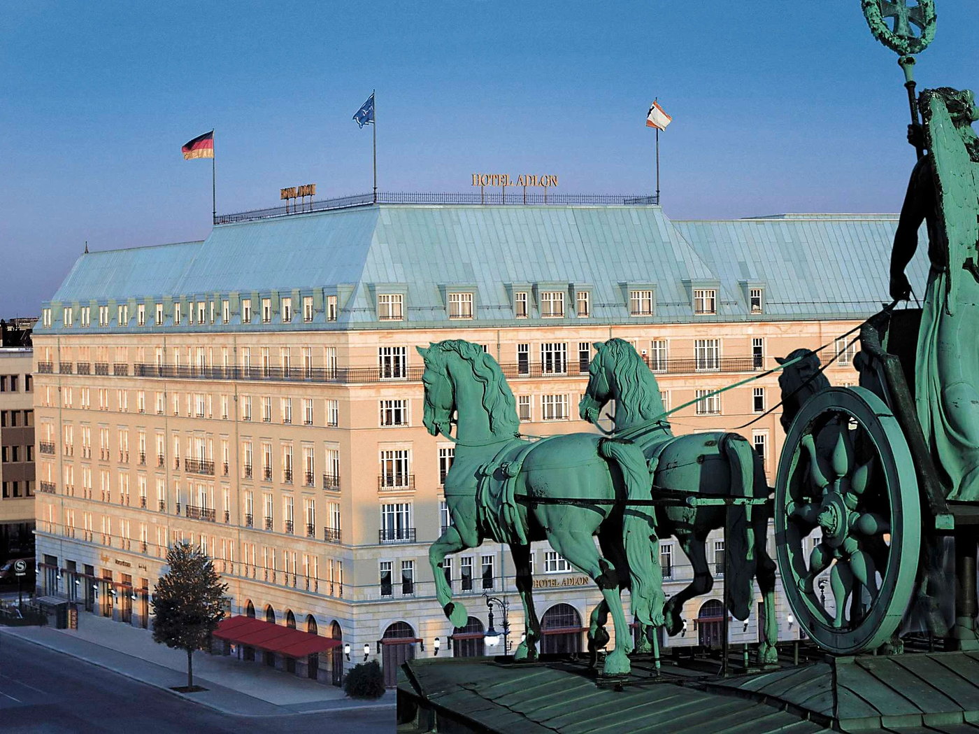 The lobby of Hotel Adlon Kempinski dressed for Christmas, a lit tree beside the Elephant Fountain